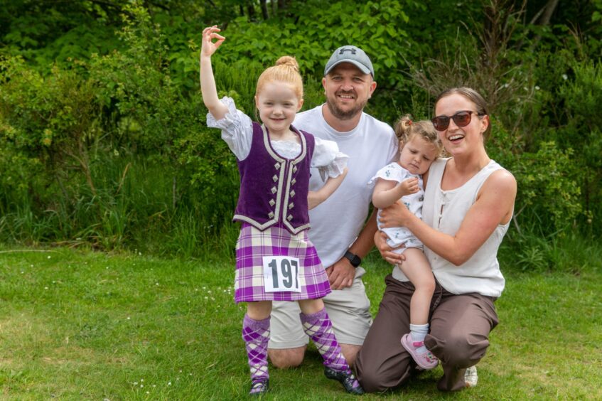 Highland dancer Orla Girdwood (4) from Kirkcaldy posing in her purple uniform with dad Tony, mum Veronica and sister Freya (2).