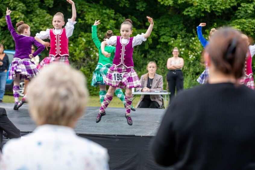 Girls compete in the Highland dancing.