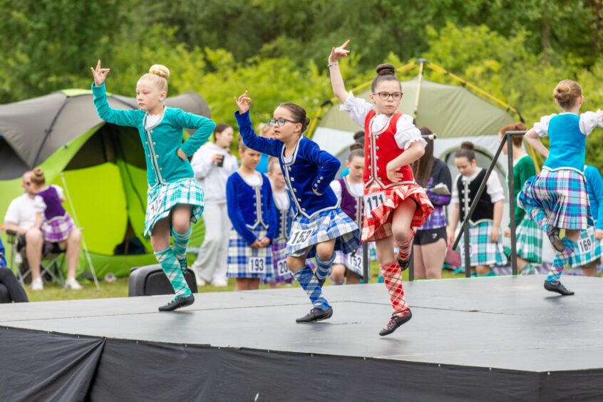 Girls compete in the Highland Dancing.