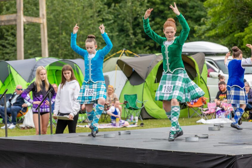 Girls compete in the Highland dancing.