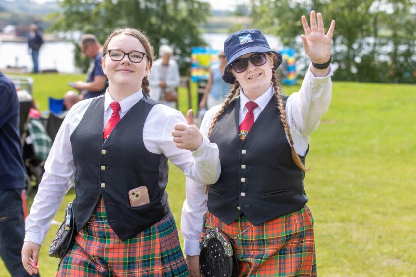 Lochgelly High School Junior band members Cara Wilson and Maisy Scott give a thumbs up and wave.
