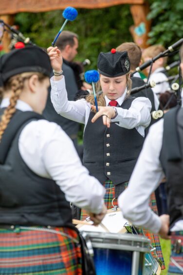 Lochgelly High School Pipe Band warms up.