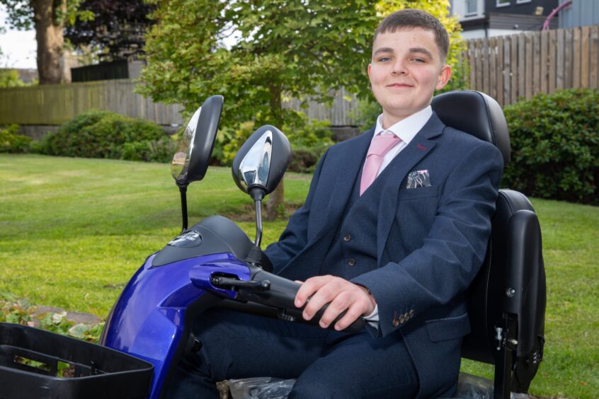 A young person in a mobility scooter 