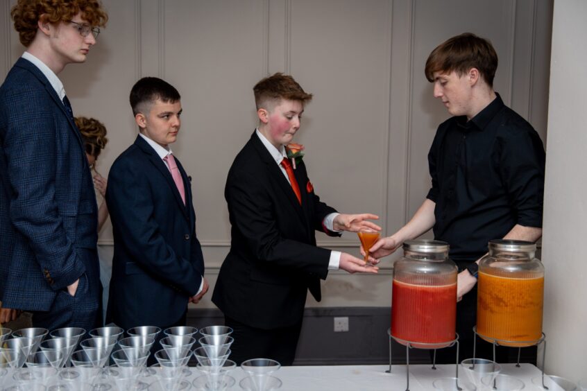 Revellers queue up for some punch. 