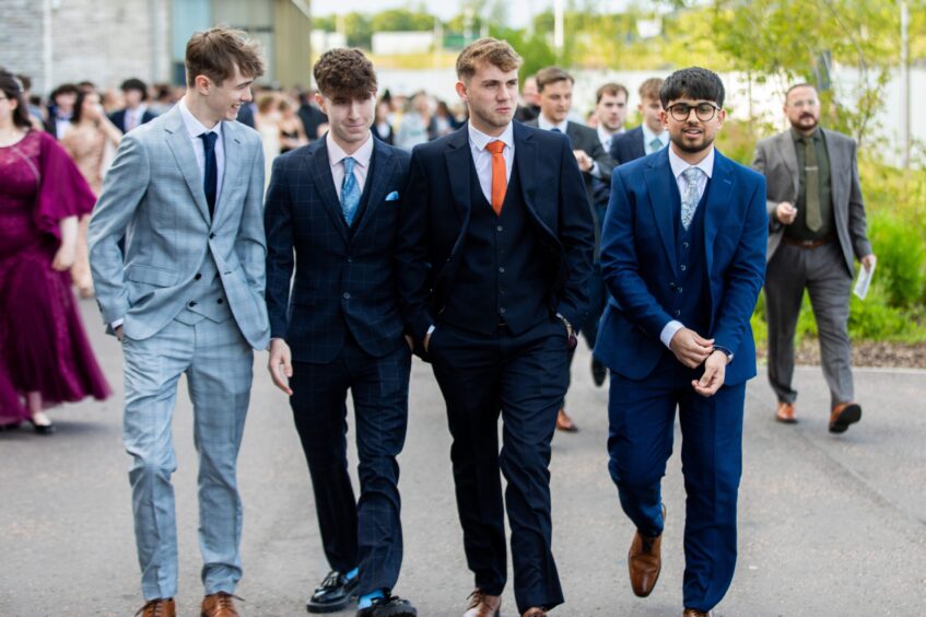 Four boys wearing suits