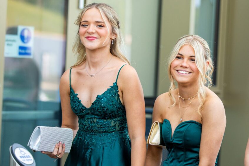 Two girls in green dresses
