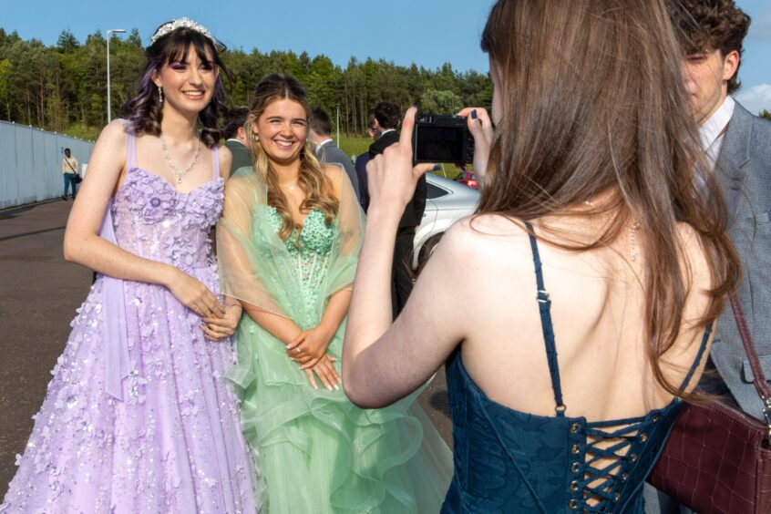 One girl takes a picture of her friends
