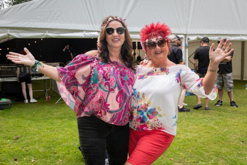 Simone Moreland from Methil and Elaine Adamson from Kirkcaldy pose with flower garlands in their hair.