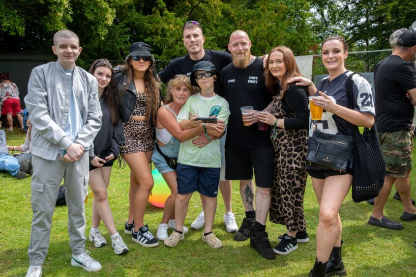 Band Tempo Event and family smile and pose, some with drinks in hand.
