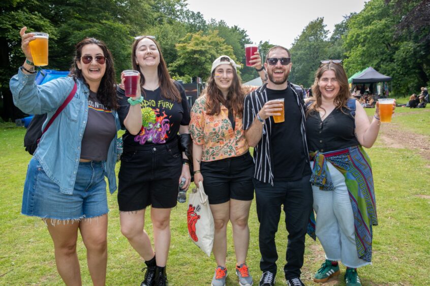 Ally, Mhairi, Freya, Declan and Jess smile and raise their pints.