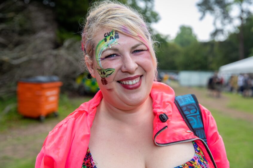 Sarah Quigley smiles. She has a small Yoda design painted on her right cheek.