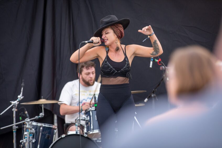 Lead singer Mo and drummer performing.