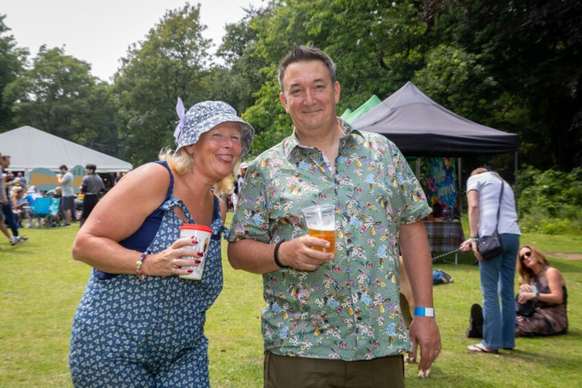 Steven and his wife pose with drinks in hand.
