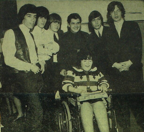 The Stones backstage with a fan at the Caird Hall in Dundee in 1964.
