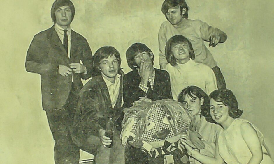 The Stones with teenage fans and a gonk backstage in Dundee in 1965.
