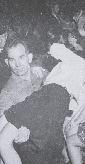 A Stones fan is removed from the hall in June 1965.