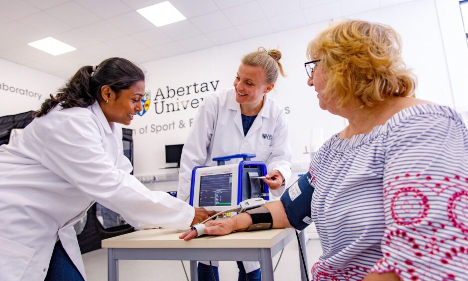 Post-Doctoral Research Fellow Vishnu Selvaraju (left) and Dr Sarah Cottin (middle) working with a study participant.