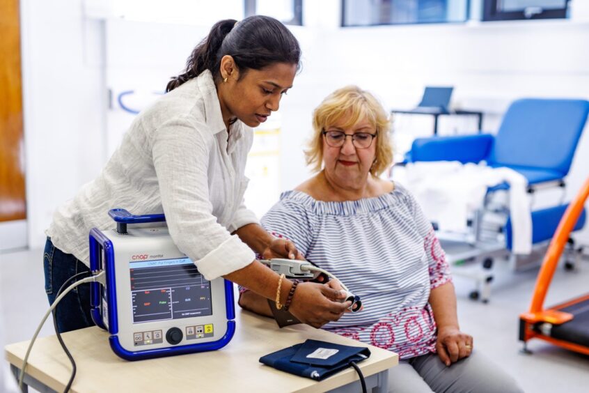 Post-Doctoral Research Fellow Vishnu Selvaraju working with a study participant.