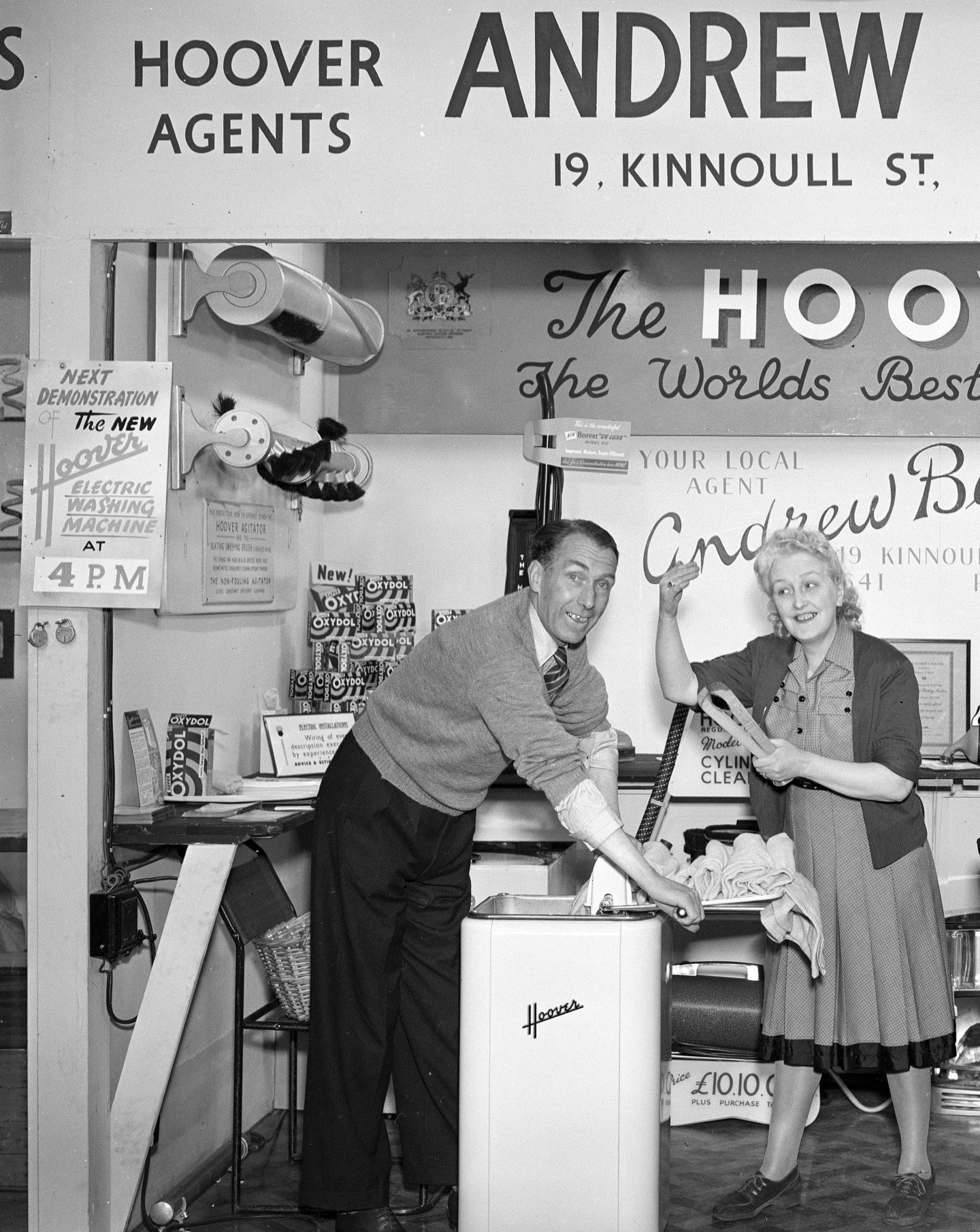 a man and a woman at a washing machine demonstration in Perth in 1949.