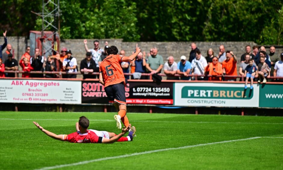 Ross Graham, No6, wheels away after his opening goal.
