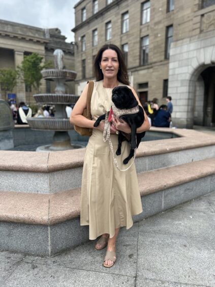 Claire Christison and her pug outside of Caird Hall.