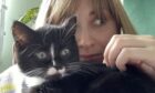 Telepathic connection? Courier writer Rebecca Baird with her cat Fable. Image: Supplied.