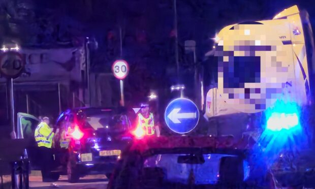 Police at the scene of the crash at the Strathmartine Road and Kingsway roundabout.
