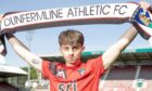 Josh Cooper holds up a Dunfermline Athletic FC scarf.