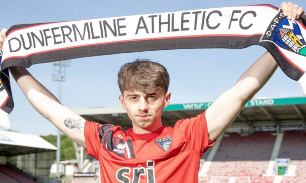 Josh Cooper holds up a Dunfermline Athletic FC scarf.