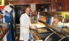 Frank Vella serving up the chips at The Victor in Blackness Road. Image: DC Thomson.