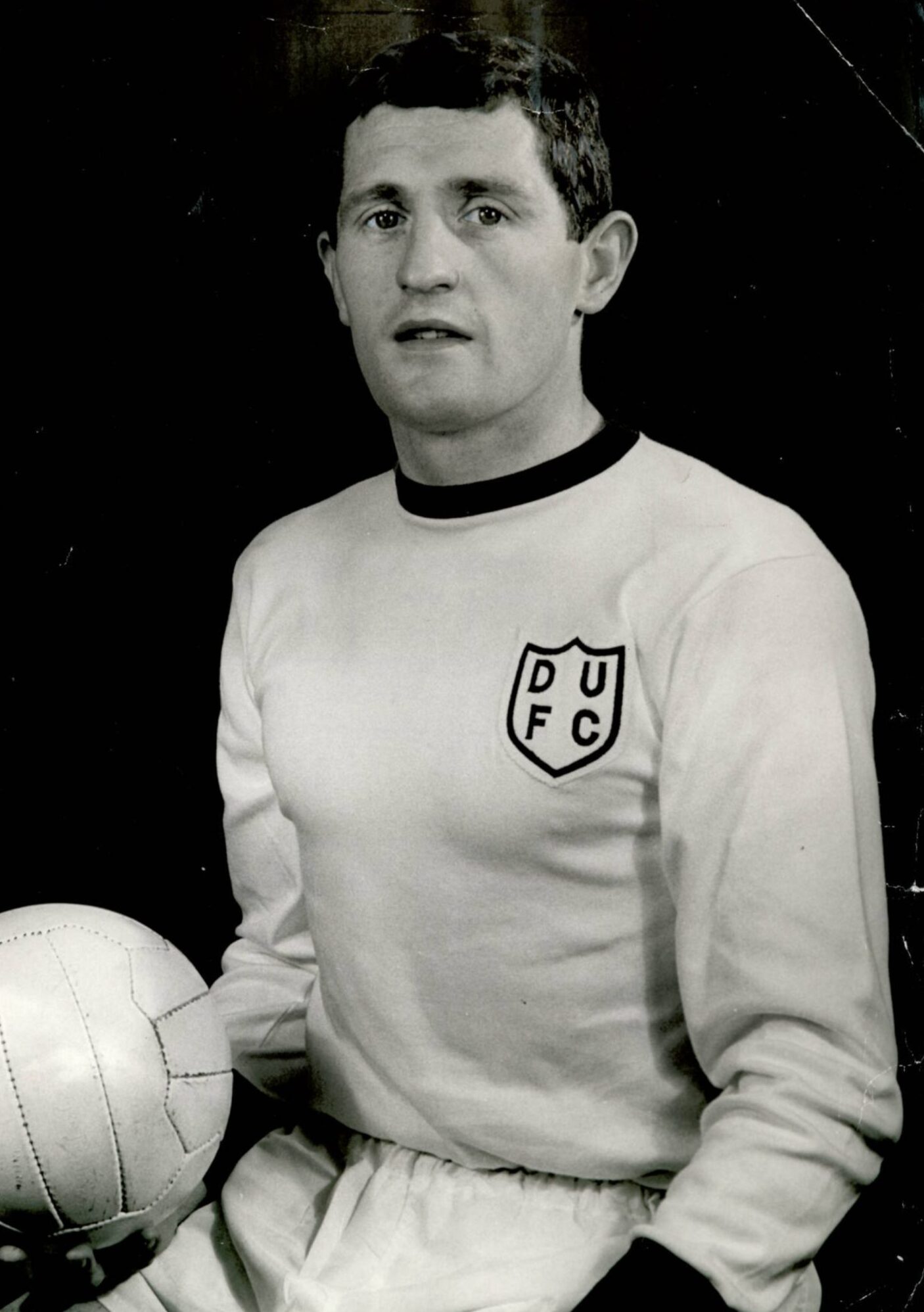 Briggs holding a ball and wearing aa Dundee United top