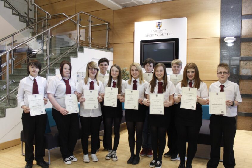 Pupils show off certificates in April 2013.