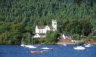 Kenmore Church with Loch tay and small boats in front