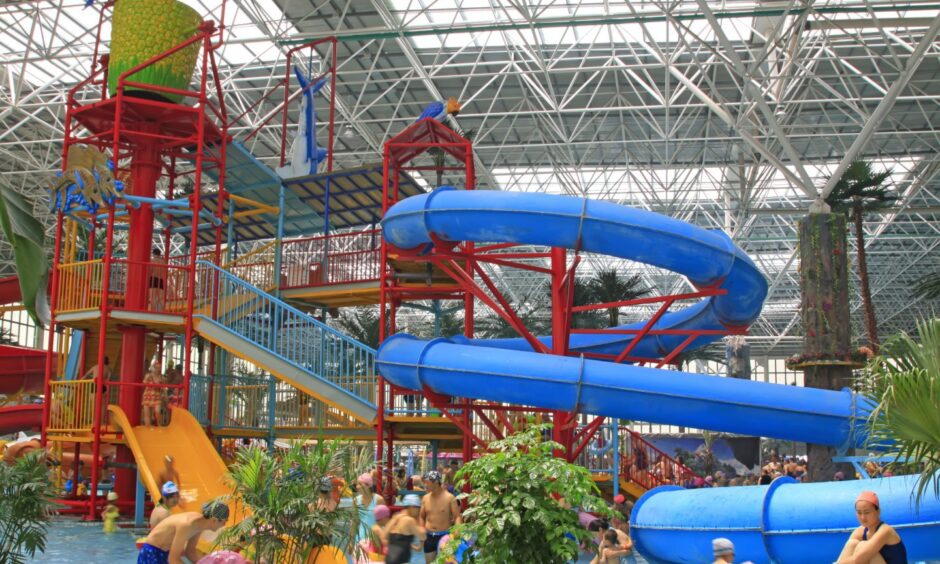 Pool with internal flumes and families playing in water