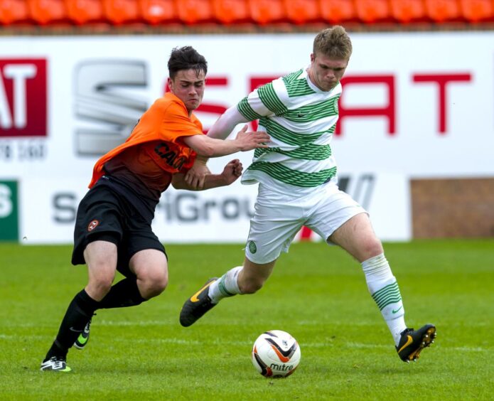 Reghan Tumilty grabs a Celtic players shirt while playing for Dundee United's under-20 team.
