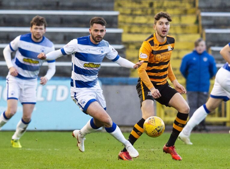 Reghan Tumilty challenges an Alloa player while playing for Morton.
