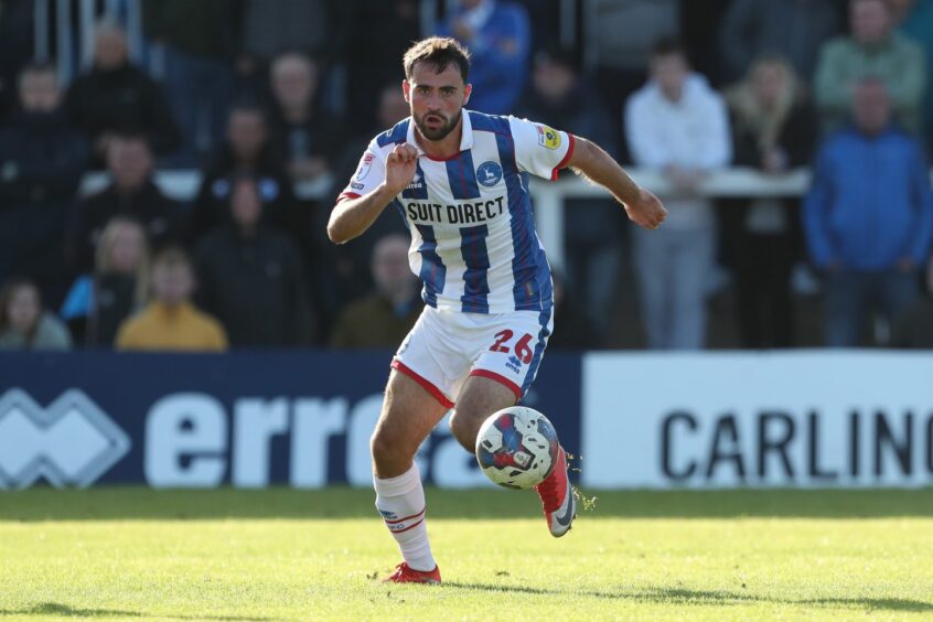 Reghan Tumilty pushes forward with the ball for Hartlepool against Gillingham.