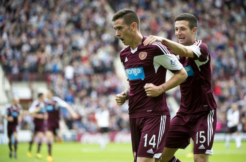 Jason Holt grabs Jamie Walker to celebrate a Hearts goal.