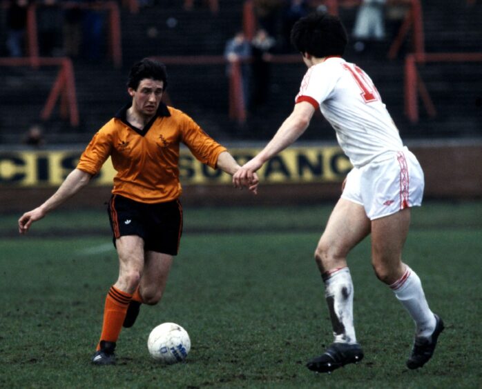 Ralph Milne with the ball at his feet as he prepares to take on a Partick Thistle defender