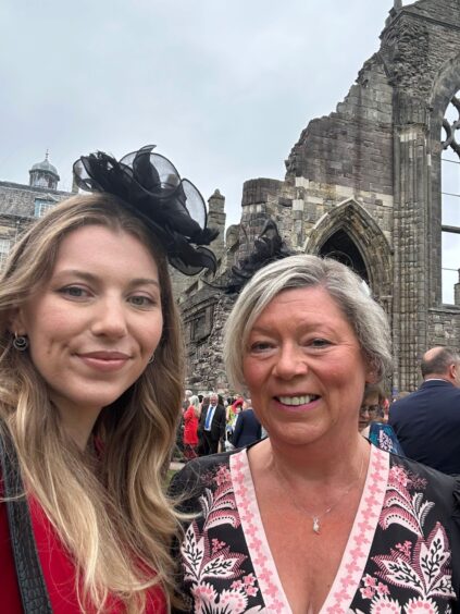 Caitlin Carroll-Adams with Morag Carroll, and palace behind
