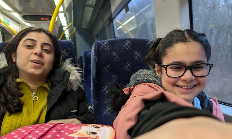 Saina on a train journey with mum Monika.