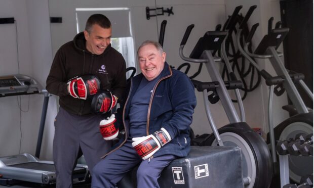 Chris Neilson helping a client keep mobile through boxing. Image: Chris Neilson