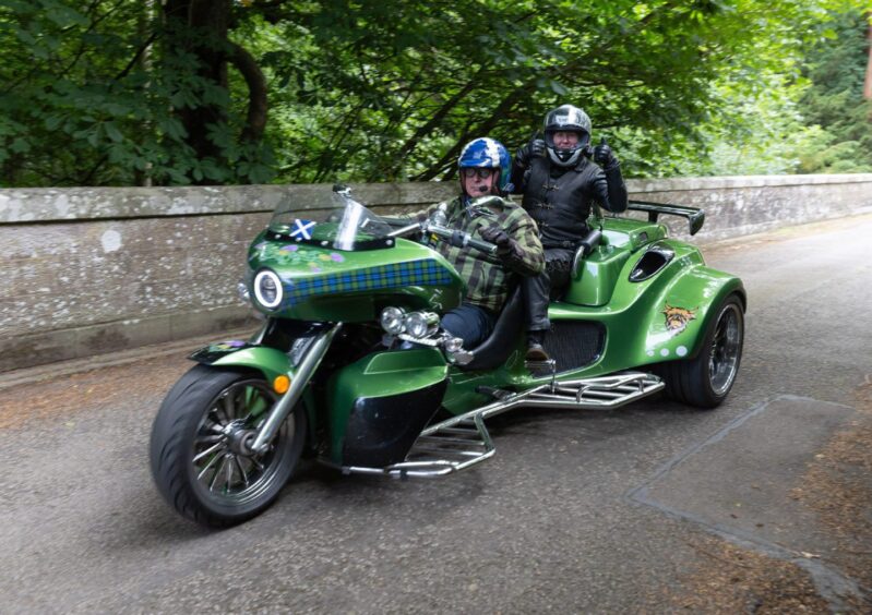 Green trike with Scottish tartan detailing takes part in the 2025 Brechin Bike and Trike Fest rideout near Brechin Castle.