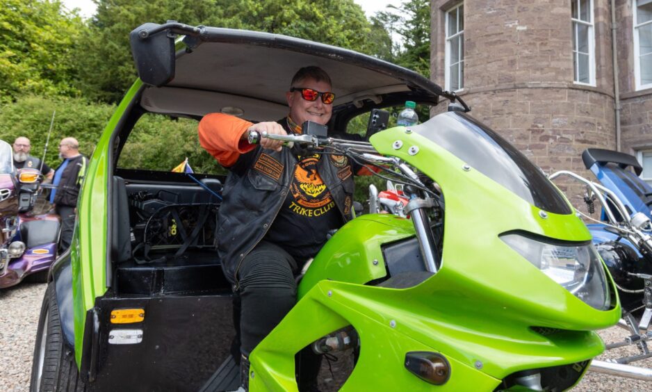Kirsty Jones from Glenrothes prepares to ride her green Smart Brabus trike at the 2025 Brechin Bike and Trike Fest.