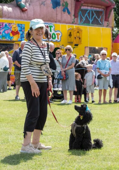 Francine Miller stands with her dog Toto during the lookalike dog competition at Carnoustie gala day 2025.