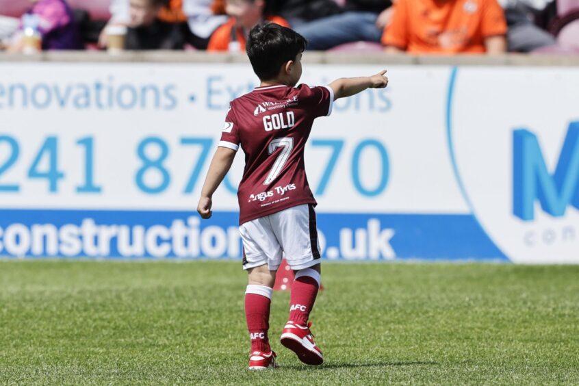 A young Arbroath fan shows their support to the man of the moment.