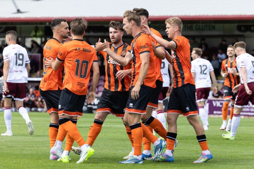 Dundee United's Bert Esselink is congratulated by his teammates.