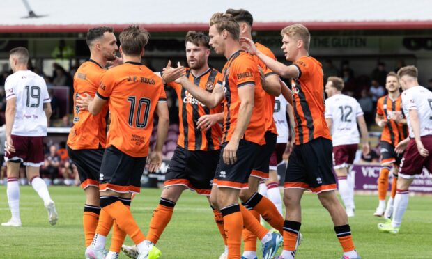 Dundee United's Bert Esselink is congratulated by his teammates.