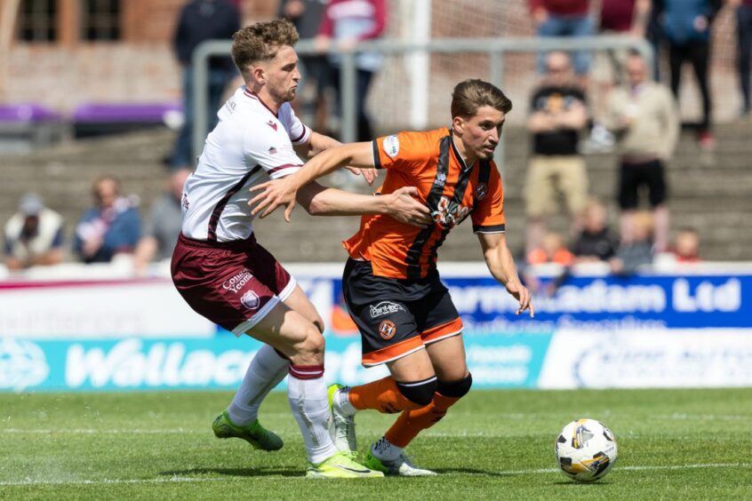 Dundee United's Dario Naamo bursts forward in possession.