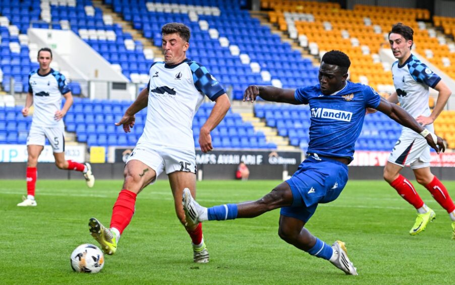 Adama Sidibeh shoots with his left foot against Falkirk.